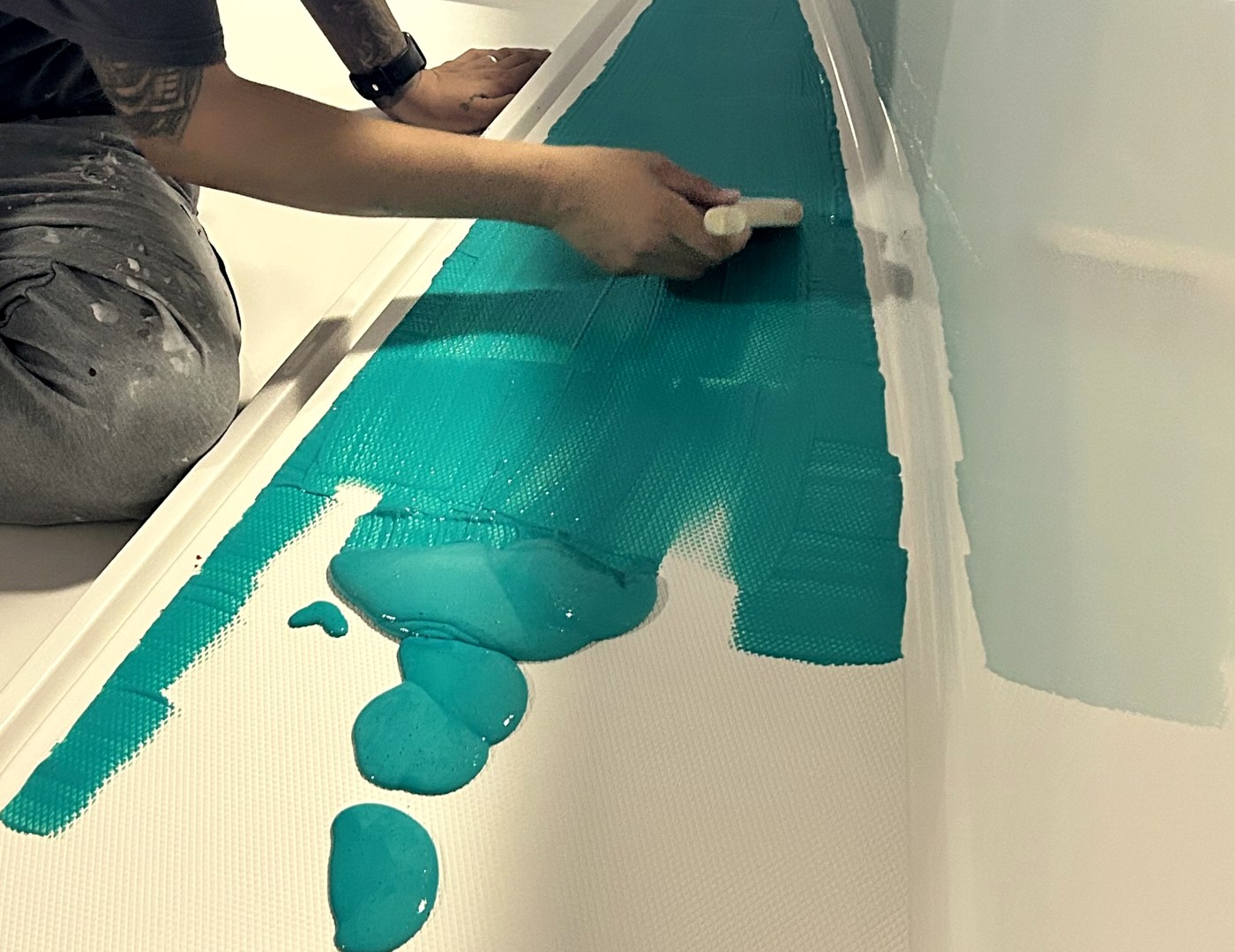 Kel-Coat 90 being brushed onto a boat deck, protecting non-skid and gelcoat during the build